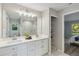Bright bathroom boasts double sinks, a large mirror, and a walk-in shower at 1463 Jinright Rd, North Port, FL 34288