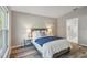Guest bedroom with gray bed and ensuite bathroom access at 1463 Jinright Rd, North Port, FL 34288