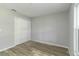 Spacious bedroom with double doors and wood-look floors at 1463 Jinright Rd, North Port, FL 34288