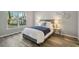 Cozy bedroom with gray bed and large window at 1463 Jinright Rd, North Port, FL 34288