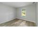 Spacious bedroom with wood flooring and a large window at 1463 Jinright Rd, North Port, FL 34288
