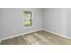 Bright bedroom with large window and wood-look floors at 1463 Jinright Rd, North Port, FL 34288