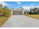 New construction home with paver driveway and landscaping at 1463 Jinright Rd, North Port, FL 34288