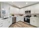Modern kitchen with white cabinets, stainless steel appliances, and quartz countertops at 1463 Jinright Rd, North Port, FL 34288