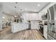 Modern kitchen with white cabinets, stainless steel appliances, and quartz countertops at 1463 Jinright Rd, North Port, FL 34288