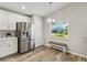 Kitchen nook with stainless steel refrigerator and bench seating at 1463 Jinright Rd, North Port, FL 34288