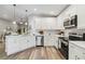 Spacious kitchen with white cabinets, stainless steel appliances, and an island at 1463 Jinright Rd, North Port, FL 34288