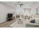 Bright and open living room with hardwood floors and a ceiling fan at 1463 Jinright Rd, North Port, FL 34288