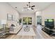 Bright living room with hardwood floors, ceiling fan, and sliding glass doors at 1463 Jinright Rd, North Port, FL 34288