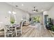 Bright and open living room with hardwood floors and a ceiling fan at 1463 Jinright Rd, North Port, FL 34288