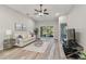 Bright living room with hardwood floors, ceiling fan, and sliding glass doors at 1463 Jinright Rd, North Port, FL 34288