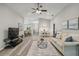 Bright and open living room with hardwood floors and a ceiling fan at 1463 Jinright Rd, North Port, FL 34288