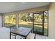 Screened porch with patio furniture and backyard view at 1463 Jinright Rd, North Port, FL 34288