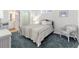 Bright bedroom with a full-size bed and wicker furniture at 1570 Monarch Dr, Venice, FL 34293