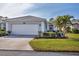 House exterior showcasing a garage and well-manicured lawn at 1570 Monarch Dr, Venice, FL 34293
