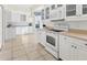 Bright kitchen with white cabinets and breakfast nook at 1570 Monarch Dr, Venice, FL 34293