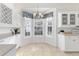 Kitchen features white cabinets, granite counters and bay window at 1570 Monarch Dr, Venice, FL 34293