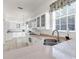 Kitchen features white cabinets, stainless steel appliances and granite countertops at 1570 Monarch Dr, Venice, FL 34293