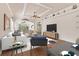 Living room with hardwood floors, staged furniture, and a mounted TV at 1570 Monarch Dr, Venice, FL 34293