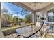 Relaxing screened porch with patio furniture and view of backyard at 1570 Monarch Dr, Venice, FL 34293