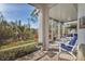 Spacious screened-in porch with seating, overlooking a lush landscape at 1570 Monarch Dr, Venice, FL 34293