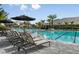 Resort-style pool with lounge chairs and umbrellas at 16630 San Nicola Pl, Lakewood Ranch, FL 34211