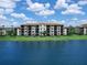 Luxury condo building with lakefront views and lush landscaping at 17108 Vardon Ter # 203, Lakewood Ranch, FL 34211