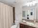 Clean bathroom with shower/tub combo, granite vanity and neutral tones at 17108 Vardon Ter # 203, Lakewood Ranch, FL 34211
