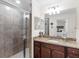 Modern bathroom with a walk-in shower, granite vanity, and neutral tile at 17108 Vardon Ter # 203, Lakewood Ranch, FL 34211