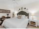 Cozy bedroom with a queen-size bed and neutral color palette, featuring a ceiling fan at 17108 Vardon Ter # 203, Lakewood Ranch, FL 34211
