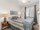 Charming bedroom with a full-size bed and a tranquil atmosphere at 17108 Vardon Ter # 203, Lakewood Ranch, FL 34211