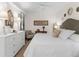Spacious bedroom with a dresser, chair, and queen-size bed, offering ample space at 17108 Vardon Ter # 203, Lakewood Ranch, FL 34211