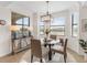 Charming dining room features a round glass table and a built-in work station at 17108 Vardon Ter # 203, Lakewood Ranch, FL 34211