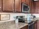 Stylish kitchen features granite countertops and modern appliances at 17108 Vardon Ter # 203, Lakewood Ranch, FL 34211