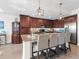 Modern kitchen with granite countertops, stainless steel appliances, and an island at 17108 Vardon Ter # 203, Lakewood Ranch, FL 34211