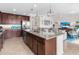 Open concept kitchen with island, granite counters & stainless steel appliances at 17108 Vardon Ter # 203, Lakewood Ranch, FL 34211