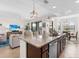 Island kitchen with granite countertops, stainless steel appliances, and breakfast bar at 17108 Vardon Ter # 203, Lakewood Ranch, FL 34211