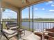 Relaxing screened lanai with wicker furniture, offering scenic water views at 17108 Vardon Ter # 203, Lakewood Ranch, FL 34211