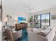 Comfortable living room with access to a balcony and water views at 17108 Vardon Ter # 203, Lakewood Ranch, FL 34211