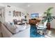 Bright living room features comfy seating, large TV, and stylish decor at 17108 Vardon Ter # 203, Lakewood Ranch, FL 34211