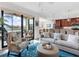 Open living room with a view of the kitchen and balcony at 17108 Vardon Ter # 203, Lakewood Ranch, FL 34211