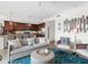 Open living space with adjacent kitchen, featuring a comfy sofa and stylish decor at 17108 Vardon Ter # 203, Lakewood Ranch, FL 34211