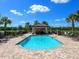 Community pool with a relaxing patio area and lounge chairs at 17108 Vardon Ter # 203, Lakewood Ranch, FL 34211