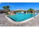Inviting pool with rock waterfall feature and lounge chairs at 17108 Vardon Ter # 203, Lakewood Ranch, FL 34211