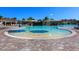 Resort-style pool with a sandy bottom and umbrellas at 17108 Vardon Ter # 203, Lakewood Ranch, FL 34211