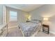 Bright bedroom featuring a comfortable bed and window shutters at 17120 Cresswind Ter, Bradenton, FL 34211