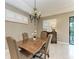 Charming dining room featuring a wooden table and elegant chandelier at 17120 Cresswind Ter, Bradenton, FL 34211