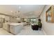 Open-concept kitchen with island, stainless steel appliances, and white cabinets at 17120 Cresswind Ter, Bradenton, FL 34211