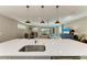 Kitchen island with sink and breakfast bar overlooking living room at 17120 Cresswind Ter, Bradenton, FL 34211