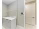 Clean laundry room with washer, dryer and shelving for storage at 17120 Cresswind Ter, Bradenton, FL 34211